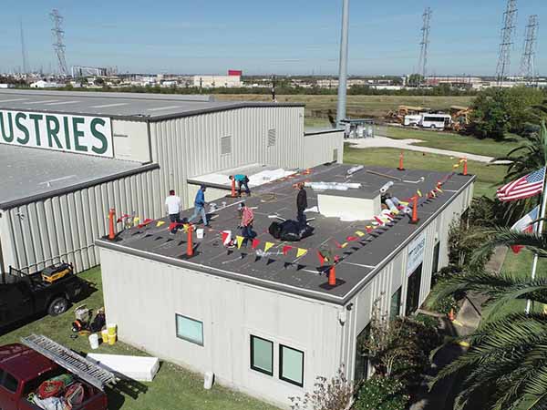 Brazosport Roofing, LLC Team installing roof on industrial building
