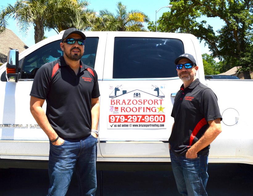 Brazosport Roofing, LLC owners standing in front of company truck